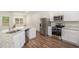 A bright kitchen with stainless steel appliances, granite countertops, and white cabinets at 225 Limestone Cir, Conyers, GA 30013