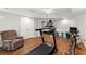 Finished basement offers a home gym with treadmill, wood floors and neutral paint at 2342 Tall Timbers Ln, Marietta, GA 30066