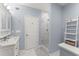 Modern bathroom with glass-enclosed shower, vanity sink, and tile floors at 2342 Tall Timbers Ln, Marietta, GA 30066