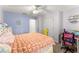 Bright bedroom featuring carpet floors, pink and blue walls, ceiling fan, and a white closet at 2342 Tall Timbers Ln, Marietta, GA 30066