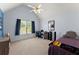 A bright bedroom includes a ceiling fan, large window, desk, and a bed at 2342 Tall Timbers Ln, Marietta, GA 30066