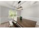 Bright dining room featuring a large window and a contemporary light fixture at 2342 Tall Timbers Ln, Marietta, GA 30066