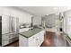Bright kitchen with white cabinetry, stainless steel appliances, and an open view to the living room at 2342 Tall Timbers Ln, Marietta, GA 30066