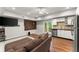 Open-concept living room with a kitchenette, wood floors, and a comfortable brown couch at 2342 Tall Timbers Ln, Marietta, GA 30066