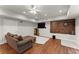Cozy living room with wood floors, comfortable sectional sofa, and entertainment center with TV at 2342 Tall Timbers Ln, Marietta, GA 30066