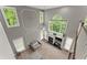 Open-concept living room with tall windows, fireplace, and neutral color palette, creating a cozy atmosphere at 2342 Tall Timbers Ln, Marietta, GA 30066