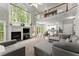 Bright and airy living room with fireplace, kitchen view, and comfortable gray sectional couch at 2342 Tall Timbers Ln, Marietta, GA 30066