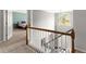 Well-lit staircase with classic wooden railing and trim leading to a cozy bedroom at 2342 Tall Timbers Ln, Marietta, GA 30066
