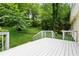 A beautiful backyard featuring a well manicured yard and a white deck overlooking the scene at 540 Alcovy Hills Dr, Lawrenceville, GA 30045