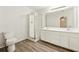 Bathroom featuring dual sinks, vanity, shower and hardwood floors at 540 Alcovy Hills Dr, Lawrenceville, GA 30045