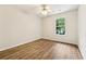 Spacious bedroom features a ceiling fan and a window with a view of the backyard at 540 Alcovy Hills Dr, Lawrenceville, GA 30045