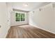 This bedroom features a large window overlooking a lush green backyard, and neutral walls at 540 Alcovy Hills Dr, Lawrenceville, GA 30045