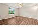 This bedroom features a ceiling fan and a window with a view of the backyard at 540 Alcovy Hills Dr, Lawrenceville, GA 30045