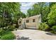 Exterior view showcasing a split-level home with a large driveway surrounded by mature trees at 540 Alcovy Hills Dr, Lawrenceville, GA 30045