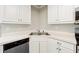 Close up of kitchen area with stainless steel sink and modern white cabinetry at 540 Alcovy Hills Dr, Lawrenceville, GA 30045