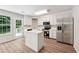 Modern kitchen with white cabinets, stainless steel appliances, and center island at 540 Alcovy Hills Dr, Lawrenceville, GA 30045