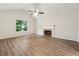 Living room with vaulted ceilings, modern ceiling fan, wood-look flooring, and fireplace at 540 Alcovy Hills Dr, Lawrenceville, GA 30045