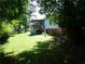 Shaded backyard with a deck and yard debris at 2900 Hitt Rd, Cumming, GA 30041