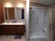 Bathroom featuring a double sink vanity and walk-in shower with a built-in seat at 2900 Hitt Rd, Cumming, GA 30041