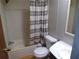 Full bathroom featuring a shower-tub combo with grey striped curtain and modern sink at 2900 Hitt Rd, Cumming, GA 30041