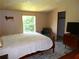 A bright bedroom with a window view, wooden furniture and a clean, comfortable bed at 2900 Hitt Rd, Cumming, GA 30041