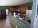 Kitchen with stainless steel appliances, a breakfast bar, and bright lighting at 2900 Hitt Rd, Cumming, GA 30041