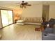 Open concept living room with plenty of light, a ceiling fan, and comfortable sectional sofa at 2900 Hitt Rd, Cumming, GA 30041
