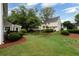 Spacious backyard features lush green grass, mature trees, and well-maintained landscaping at 303 Roswell Green Ln, Roswell, GA 30075