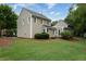 Backyard with grass, trees, and patio with glass doors at 303 Roswell Green Ln, Roswell, GA 30075
