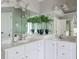 Bathroom with double sink vanity, ample mirrors, and bright lighting at 303 Roswell Green Ln, Roswell, GA 30075