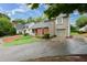 Home exterior features brick, siding, and a well-manicured front lawn at 303 Roswell Green Ln, Roswell, GA 30075