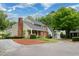 Home exterior featuring a brick facade, siding, and a well-maintained landscape at 303 Roswell Green Ln, Roswell, GA 30075