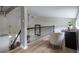 Upstairs hallway featuring a neutral color palette and a black iron railing at 303 Roswell Green Ln, Roswell, GA 30075