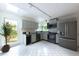 Bright kitchen with stainless steel appliances, ample counter space, and white tile floors at 303 Roswell Green Ln, Roswell, GA 30075