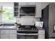 Well-lit kitchen boasts modern appliances and stylish backsplash, enhancing its functionality and appeal at 303 Roswell Green Ln, Roswell, GA 30075