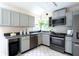 Well-lit kitchen with stainless steel appliances and ample counter space at 303 Roswell Green Ln, Roswell, GA 30075
