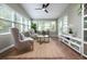 Inviting sunroom with skylights, a ceiling fan, and lots of natural light at 303 Roswell Green Ln, Roswell, GA 30075