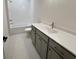 Modern bathroom with tile flooring, grey vanity, and bathtub at 435 Chiswick Cir # 21, Alpharetta, GA 30009