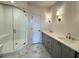 Bathroom featuring tiled floors, a glass shower door, and a double vanity at 435 Chiswick Cir # 21, Alpharetta, GA 30009
