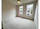 A bright bedroom with neutral carpet, two windows, and recess lighting at 435 Chiswick Cir # 21, Alpharetta, GA 30009