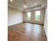 A spacious bedroom featuring hardwood floors, tray ceilings, and two large windows at 435 Chiswick Cir # 21, Alpharetta, GA 30009