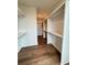 Walk-in closet featuring shelves and drawers, and hardwood floors at 435 Chiswick Cir # 21, Alpharetta, GA 30009