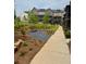 Exterior view of new brick townhomes with bench seating and grassy spaces at 435 Chiswick Cir # 21, Alpharetta, GA 30009
