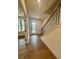 Inviting foyer with hardwood floors, white walls, and a staircase at 435 Chiswick Cir # 21, Alpharetta, GA 30009