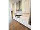 Kitchen featuring white cabinets, stainless hood, and gas range at 435 Chiswick Cir # 21, Alpharetta, GA 30009