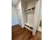 Mudroom with built-in bench, cubbies, and hardwood flooring at 435 Chiswick Cir # 21, Alpharetta, GA 30009