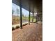 Spacious patio with brick flooring, grey pillars and landscaping at 435 Chiswick Cir # 21, Alpharetta, GA 30009