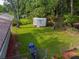 Spacious backyard with a shed, surrounded by lush trees and a chainlink fence at 5207 Dixie Lake Rd, Union City, GA 30291