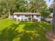 Charming single-story brick home with a well-manicured lawn and mature trees, showcasing curb appeal at 5207 Dixie Lake Rd, Union City, GA 30291