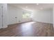 Bright living room featuring wood-look floors, a large window, and fresh paint, creating an inviting space at 5207 Dixie Lake Rd, Union City, GA 30291
